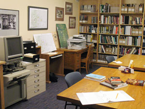 A desk, computer, and books in an office