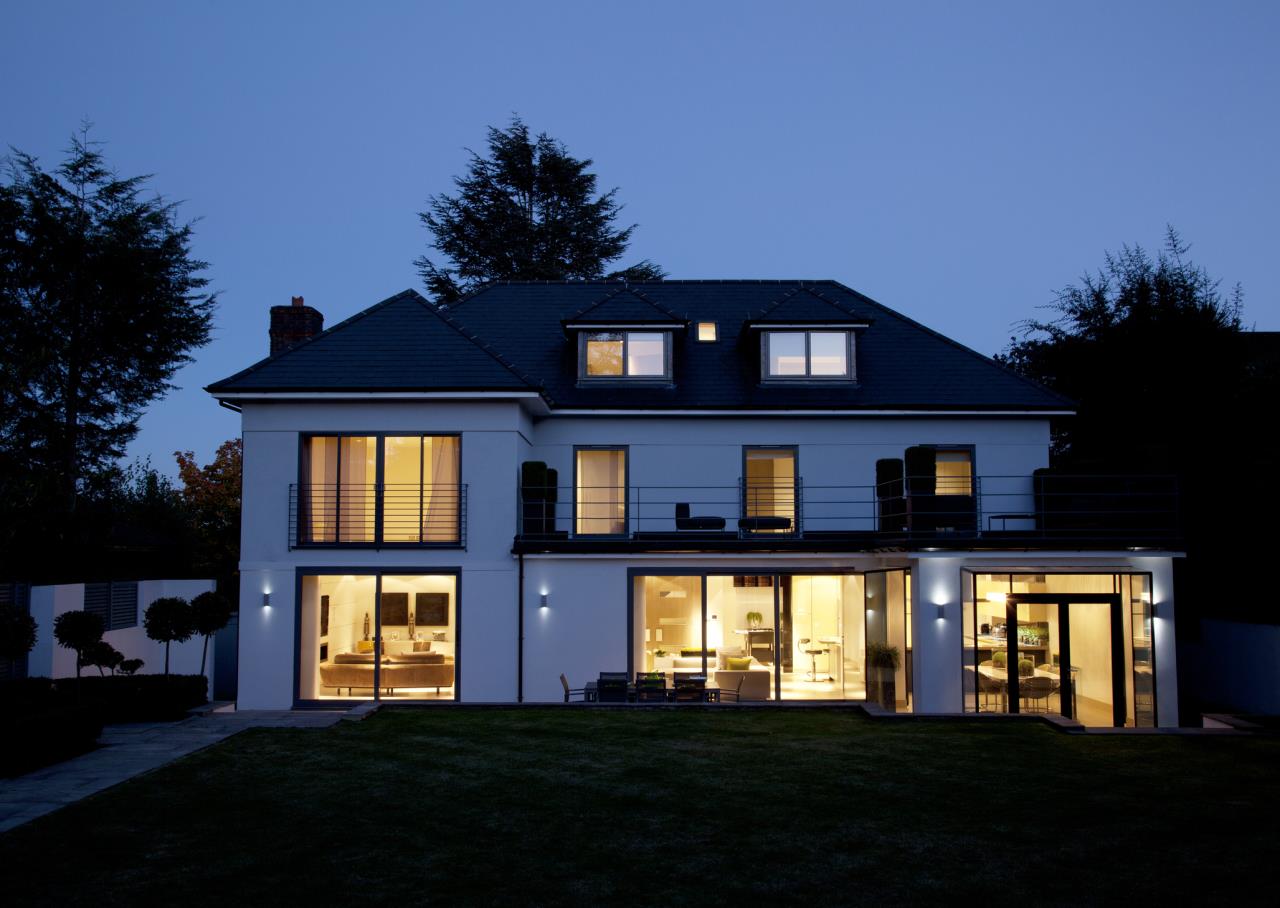 Well-lit two-story home at night