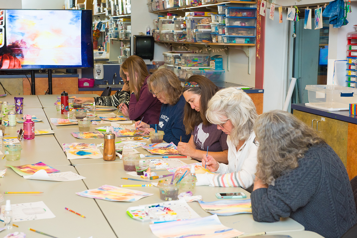 A group of women working on a painting project