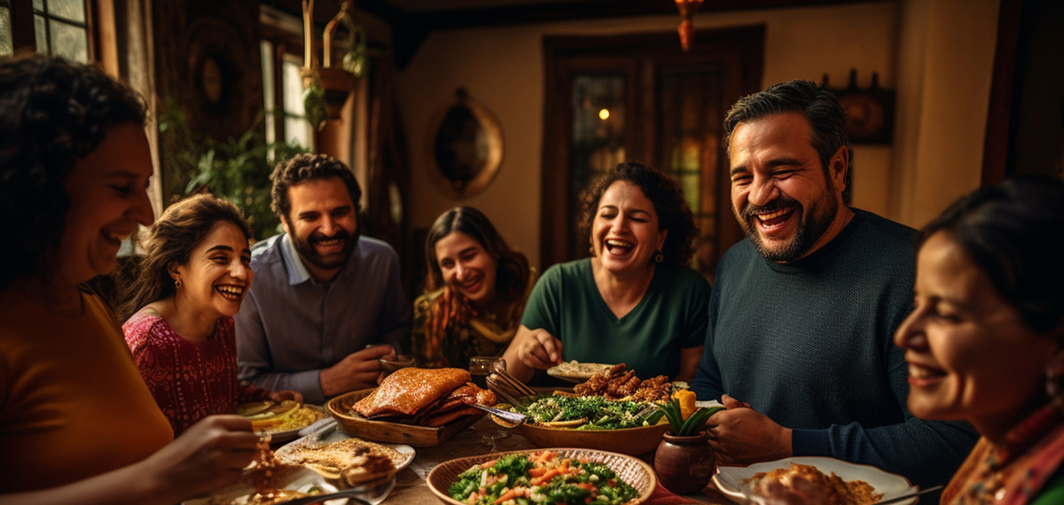 A family of six laughs around a dinner table.