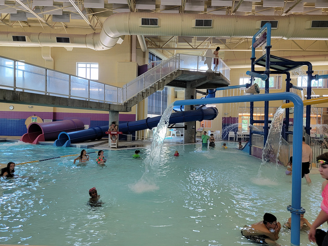 Leisure pool at Longmont Recreation Center with view of the two slides and spray features.