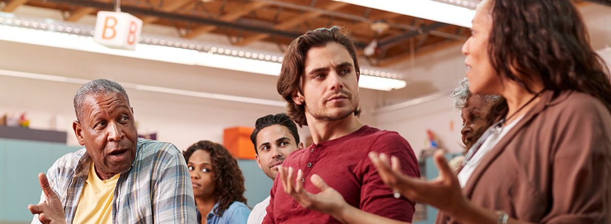 People in discussion at a neighborhood meeting