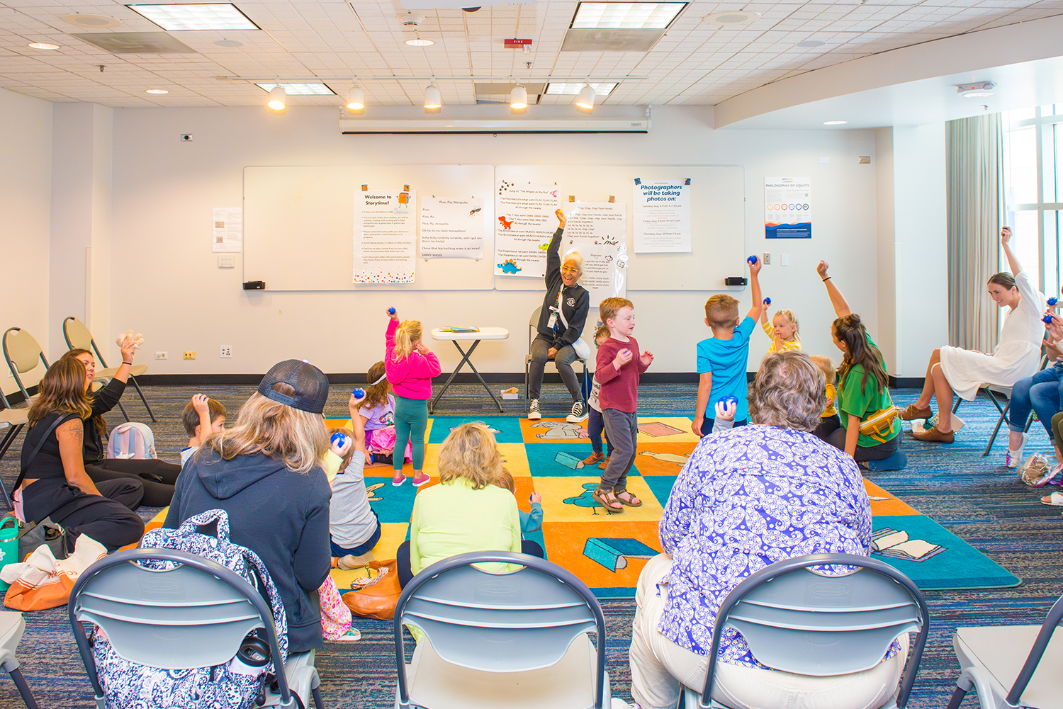 Children and parents dance during the Library's storytime