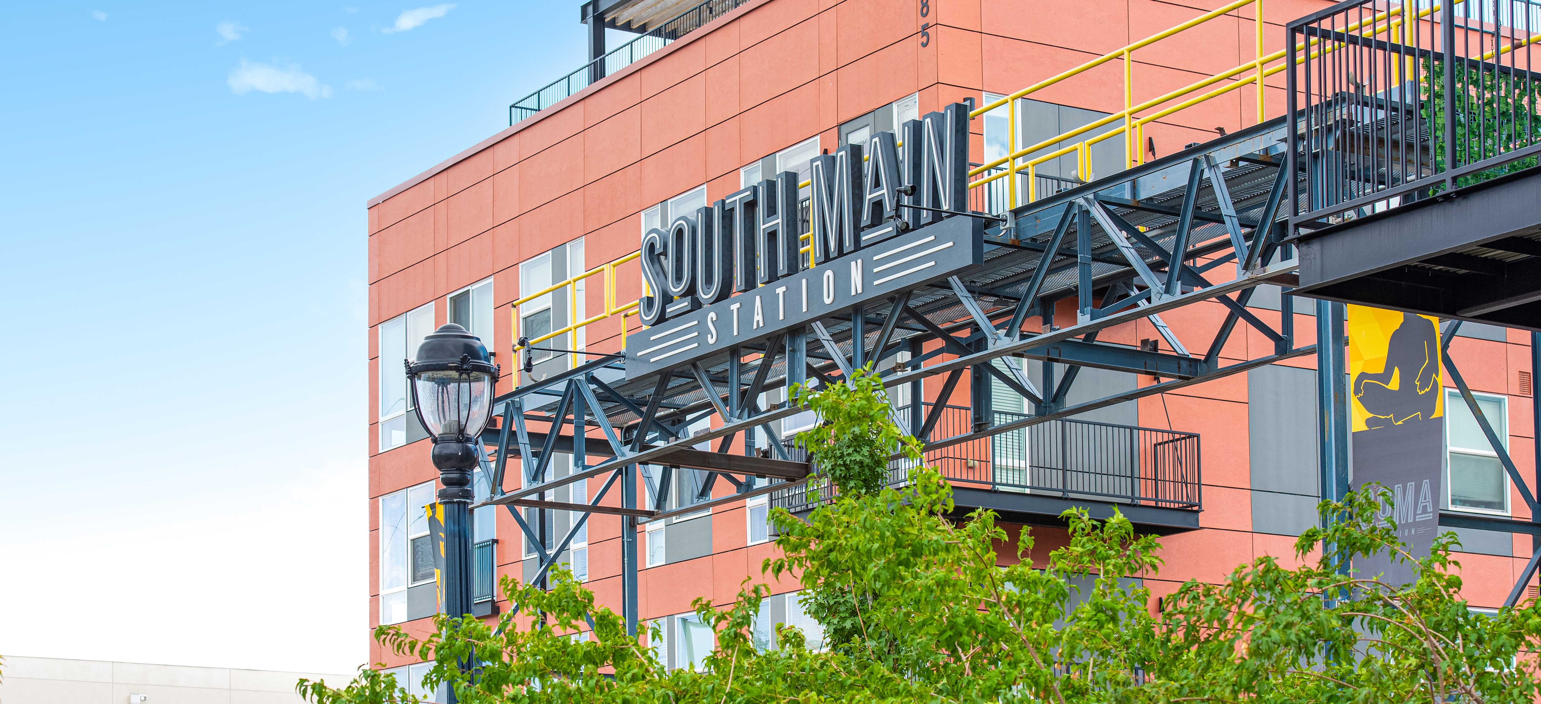 South Main Station Sign above the trees on Main Street